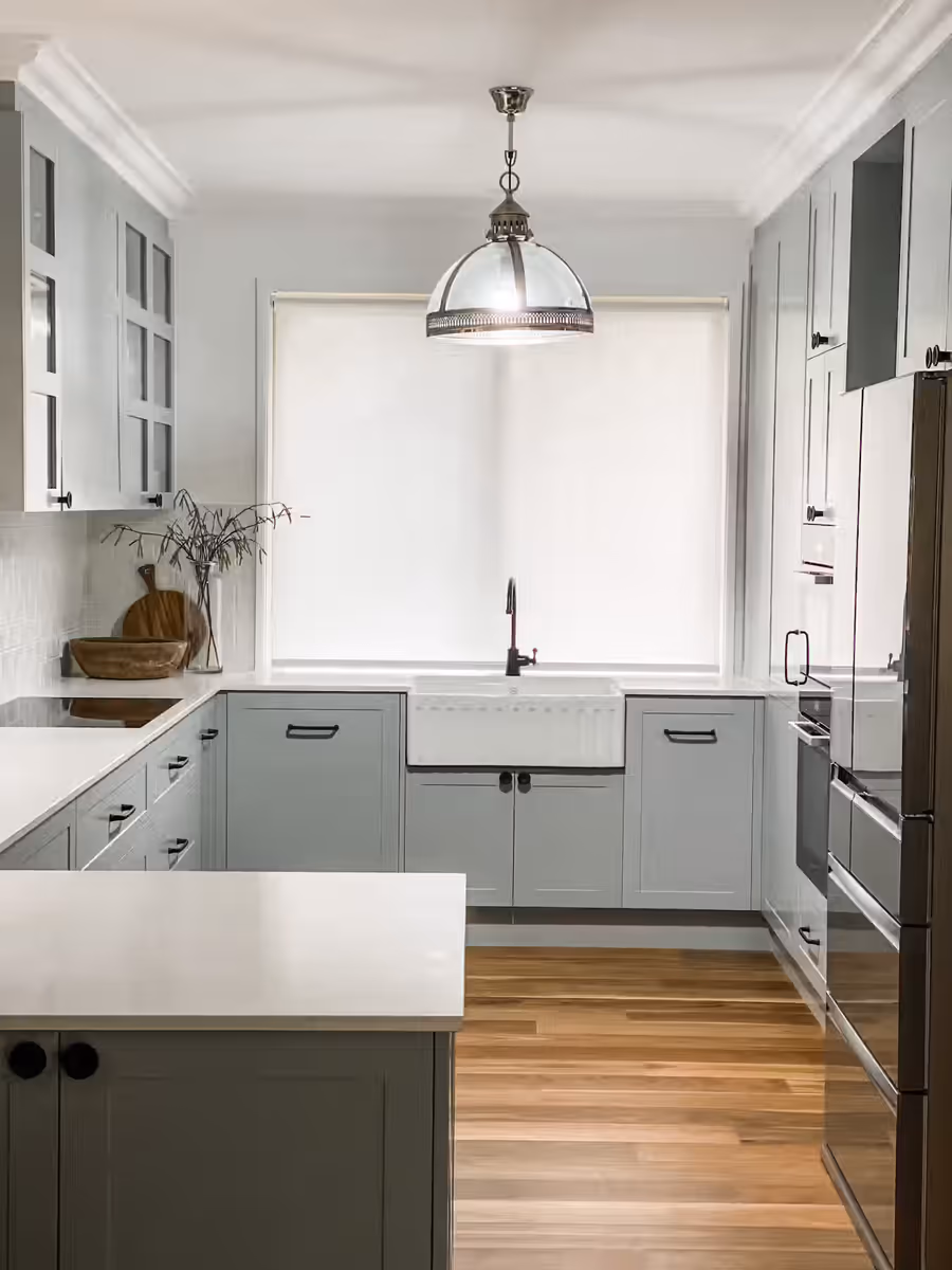 Sage green shaker kitchen with a farmhouse sink and a chrome dome pendant